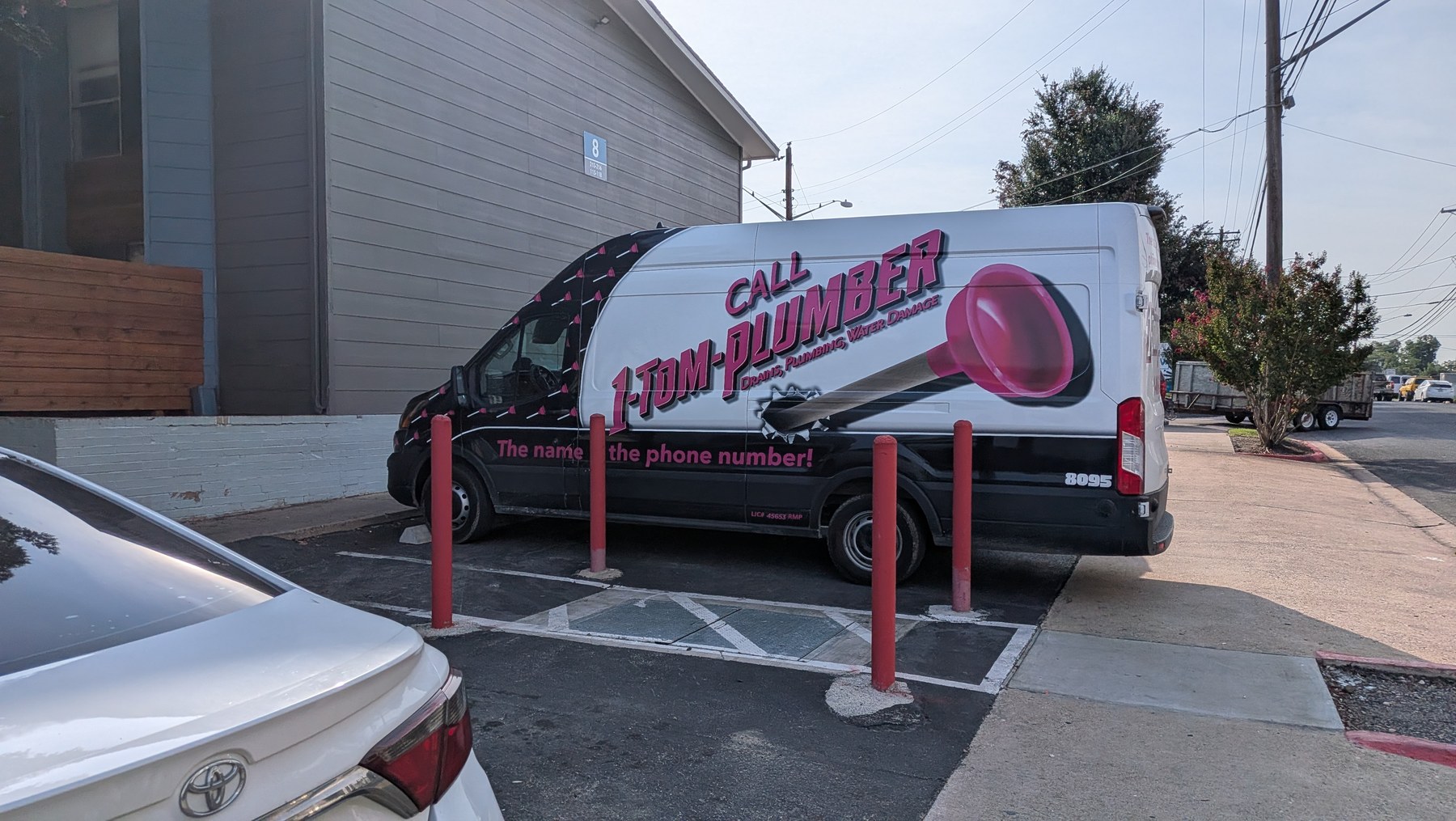 1-Tom-Plumber service van with giant pink plunger graphic