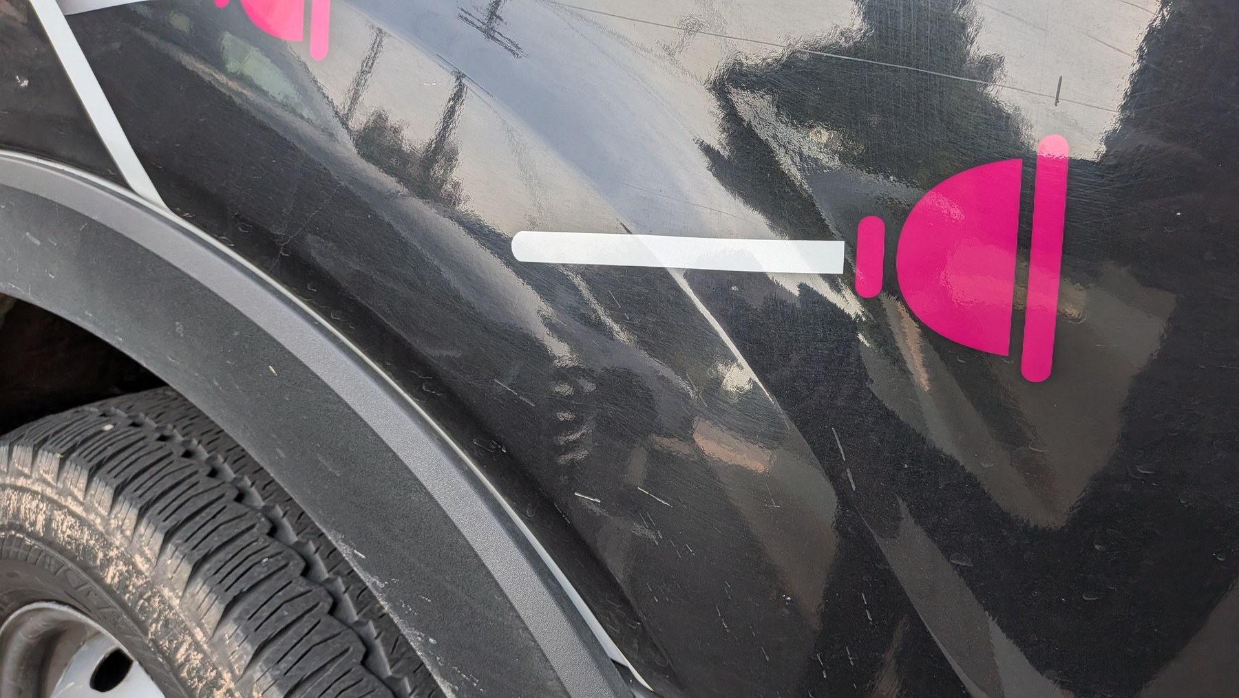 Close-up of giant pink plunger vehicle graphic