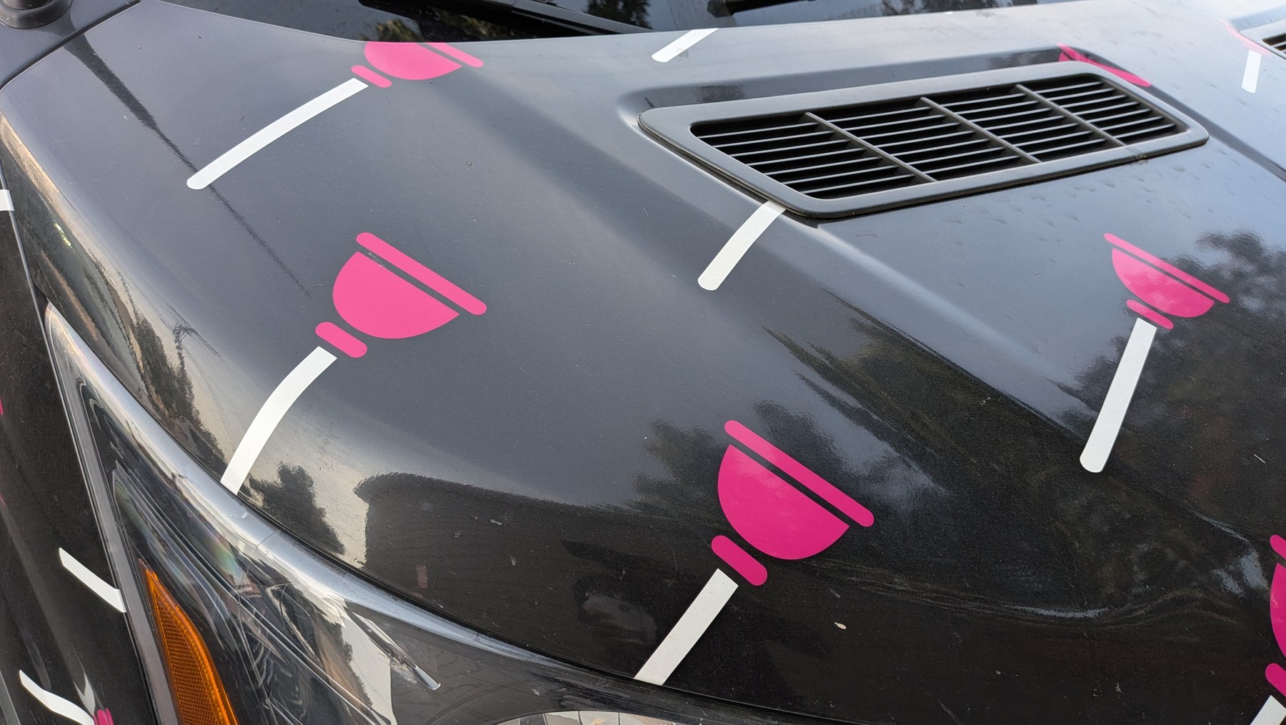 Close-up of pink plunger vehicle wrap pattern
